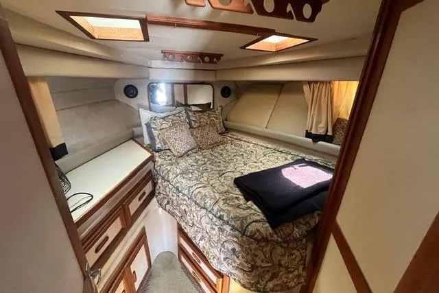 Slide: The Image of 1989 Carver 3297 Mariner cabin interior with bed, storage, and skylights. - 19