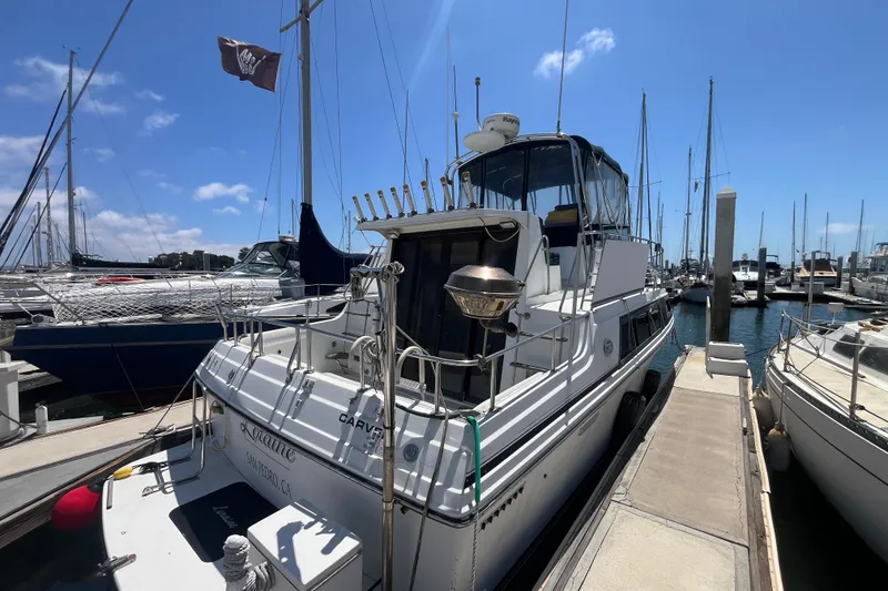 Slide: The Image of 1989 Carver 3297 Mariner yacht docked at marina under clear blue sky. - 2