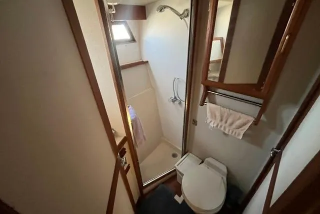 Slide: The Image of Bathroom interior of 1989 Carver 3297 Mariner yacht, featuring shower and toilet. - 20