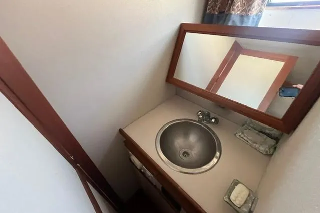 Slide: The Image of Compact bathroom sink area in a 1989 Carver 3297 Mariner boat. - 21