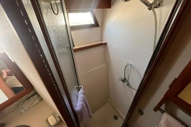 Slide: The Image of Shower area in 1989 Carver 3297 Mariner boat with window and towel. - 22