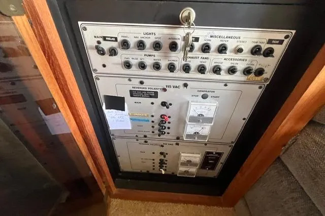 Slide: The Image of Control panel of a 1989 Carver 3297 Mariner boat, featuring various switches and indicators. - 23