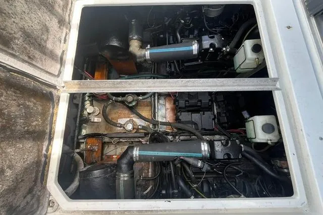 Slide: The Image of Engine compartment of a 1989 Carver 3297 Mariner boat, showing mechanical components. - 24