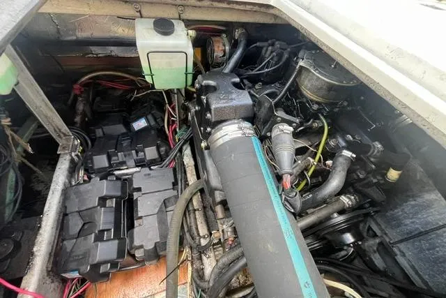 Slide: The Image of Engine compartment of a 1989 Carver 3297 Mariner, showcasing wiring and mechanical components. - 25