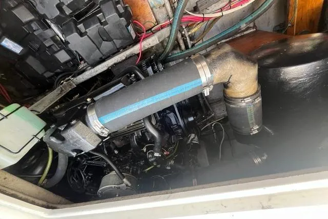 Slide: The Image of Engine compartment of a 1989 Carver 3297 Mariner boat, showcasing mechanical components. - 26