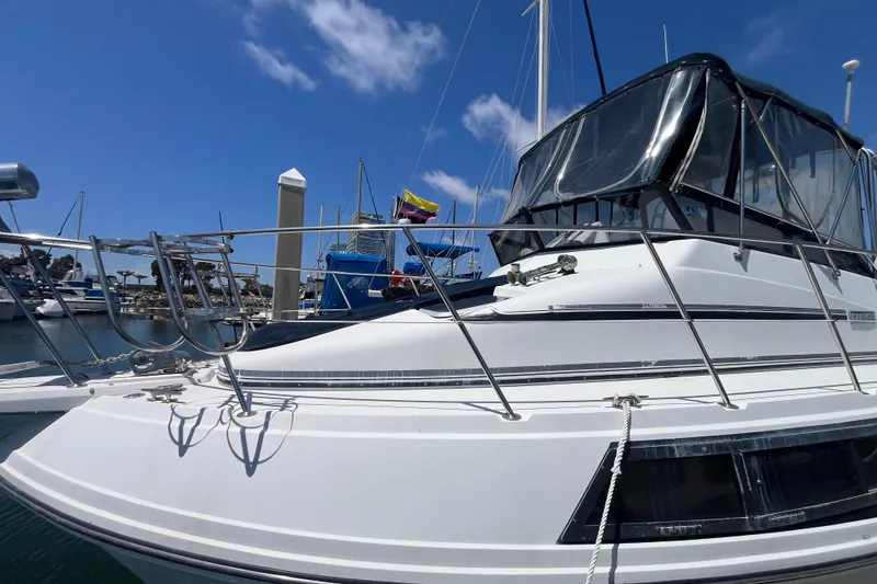 Slide: The Image of 1989 Carver 3297 Mariner yacht docked at marina under clear blue sky. - 3