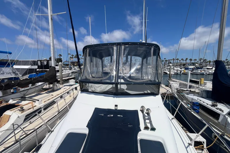 Slide: The Image of 1989 Carver 3297 Mariner yacht docked at a marina under a clear blue sky. - 6