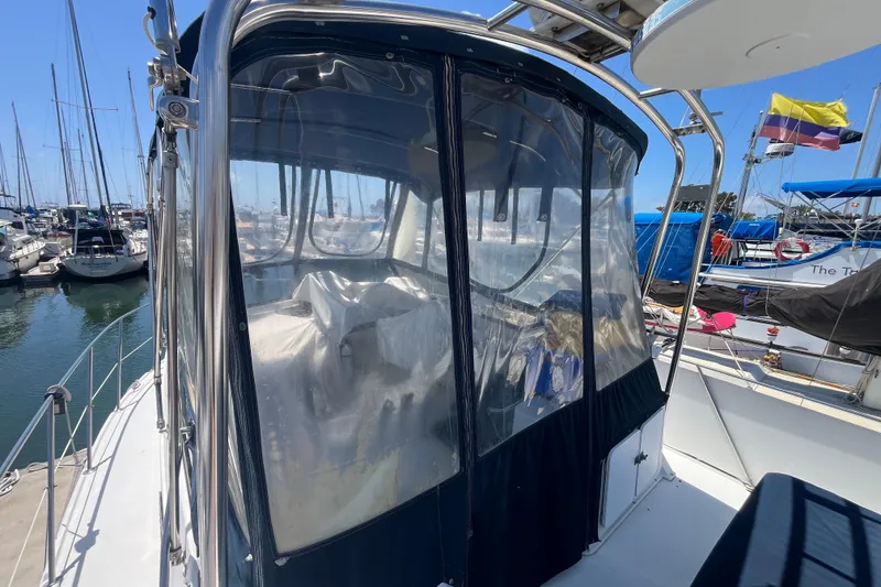 Slide: The Image of 1989 Carver 3297 Mariner yacht with clear enclosure, docked in a marina. - 7