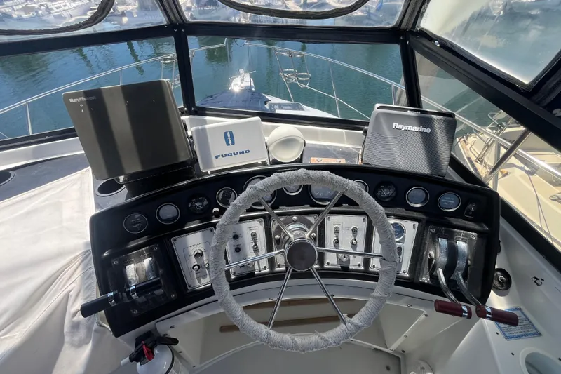 Slide: The Image of Helm of 1989 Carver 3297 Mariner with navigation equipment and steering wheel. - 9