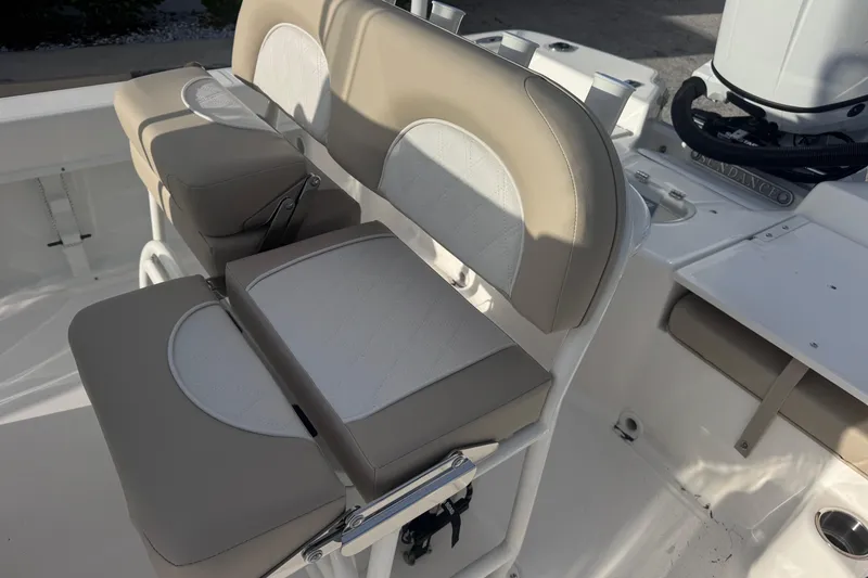 Slide: The Image of 2026 Sundance DX22 boat seating with beige and white cushioned design. - 10