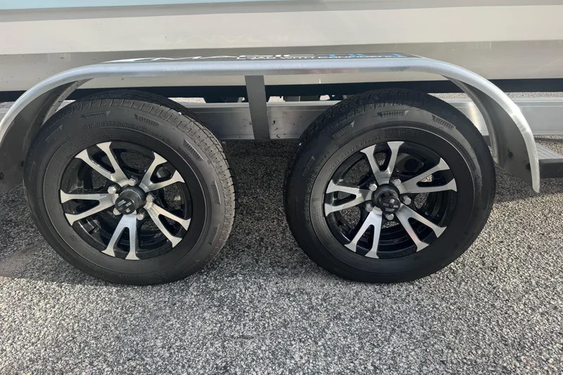 Slide: The Image of 2026 Sundance DX22 trailer wheels on asphalt surface. - 13