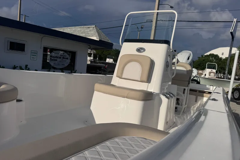 Slide: The Image of 2026 Sundance DX22 boat at a dealership, showcasing sleek design and modern features. - 8