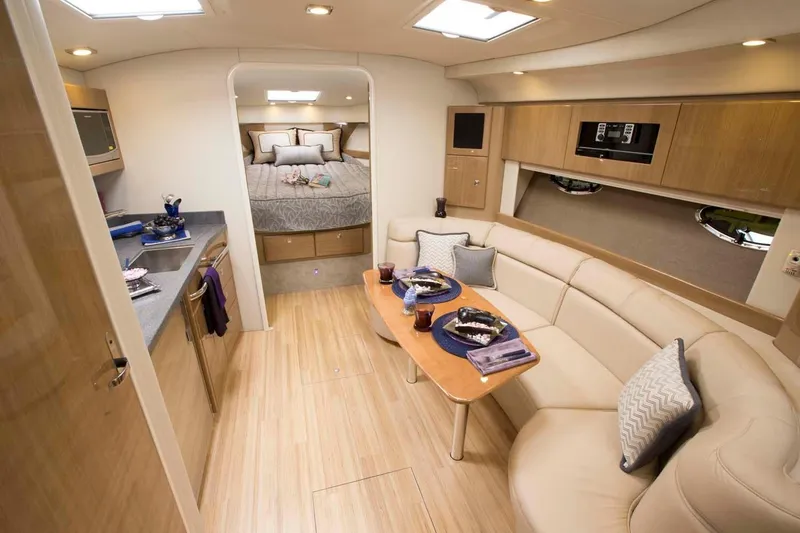 Slide: The Image of Manufacturer Provided Image: 2019 Formula 37 Performance Cruiser interior with modern kitchen, dining area, and cozy bedroom. - 13