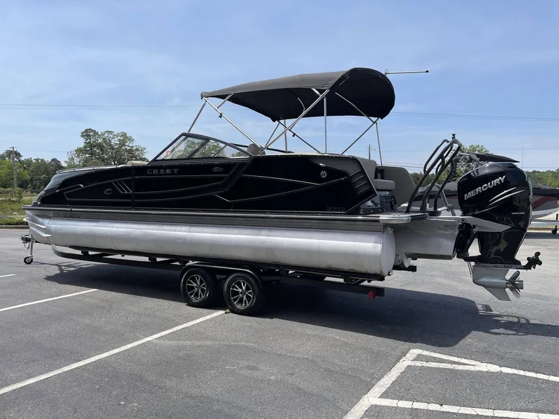 Slide: The Image of 2021 Crest 270 Continental pontoon boat on trailer outdoors. - 18