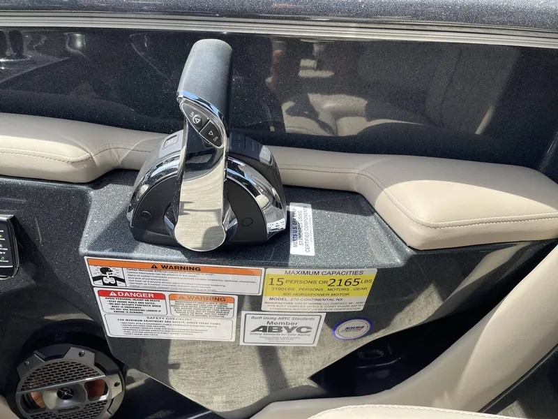 Slide: The Image of Interior view of a 2021 Crest 270 Continental boat with throttle lever. - 34