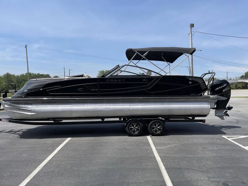 Slide: The Image of 2021 Crest 270 Continental pontoon boat on trailer outdoors. - 40