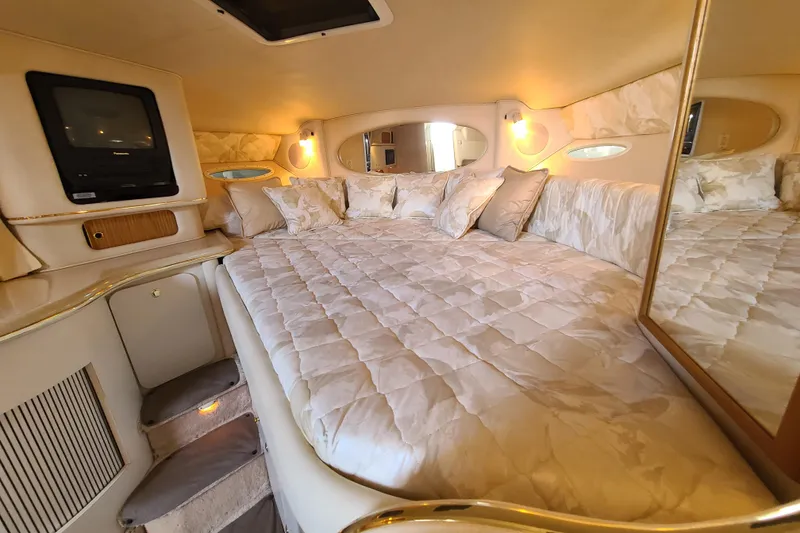 Slide: The Image of Luxurious interior cabin of 1999 Sea Ray Sundancer 310 yacht with plush bedding. - 10