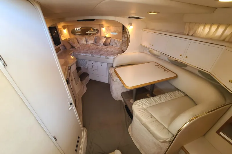 Slide: The Image of Interior of 1999 Sea Ray Sundancer 310 yacht with cozy seating and sleeping area. - 14