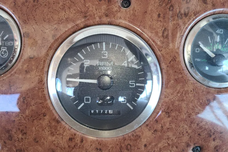 Slide: The Image of Tachometer on 1999 Sea Ray Sundancer 310 boat dashboard, showing RPM readings. - 16