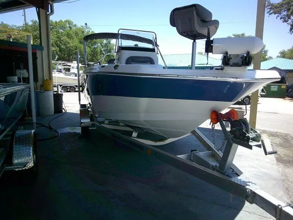 Slide: The Image of 2024 NauticStar 211 Hybrid boat on trailer in workshop. - 3