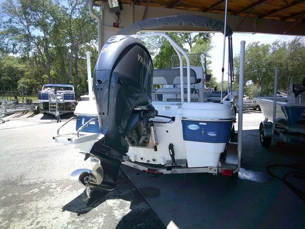 Slide: The Image of 2024 NauticStar 211 Hybrid boat with outboard motor. - 5