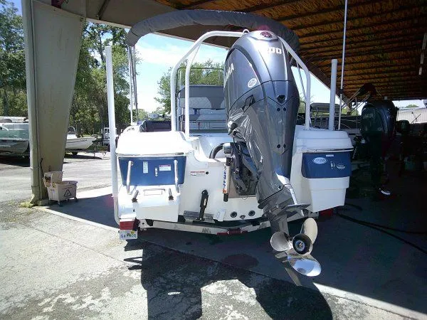 Slide: The Image of 2024 NauticStar 211 Hybrid boat with outboard motor. - 6