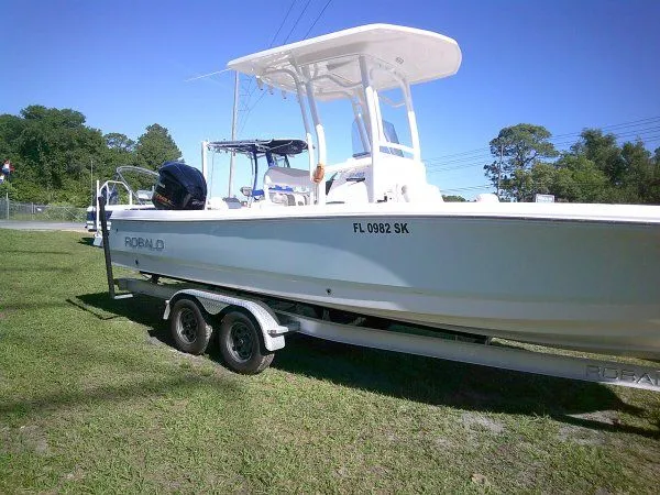 Slide: The Image of 2017 Robalo 246 Cayman boat parked on trailer outdoors. - 4