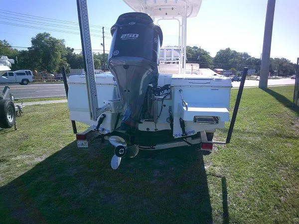 Slide: The Image of 2017 Robalo 246 Cayman with outboard motor parked on grass. - 6