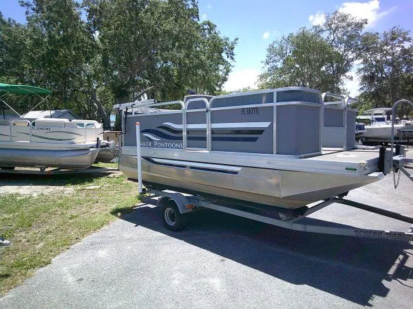 The Image of 2022 PlayCraft Laker 14' Minitoon pontoon boat on trailer. - 1
