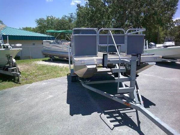 Slide: The Image of PlayCraft Laker 14' Minitoon 2022 on trailer outdoors. - 3