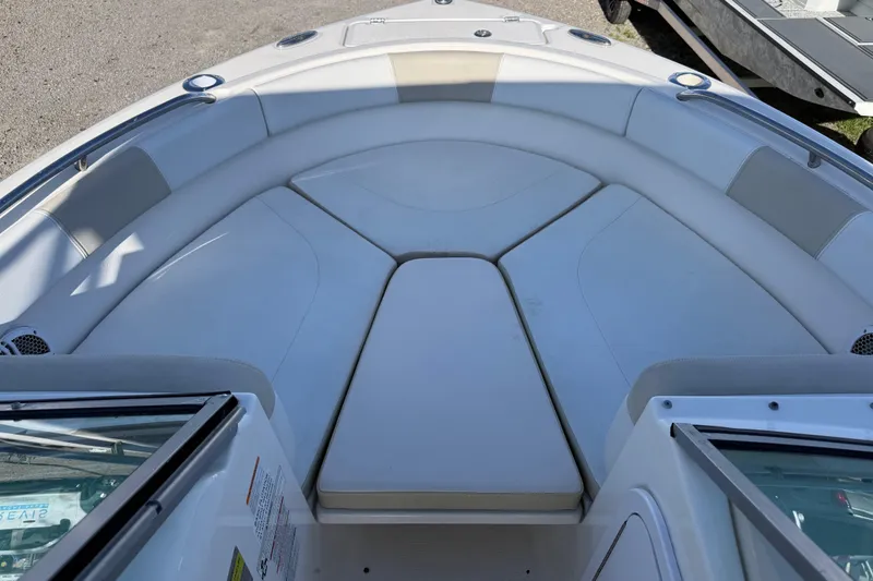 Slide: The Image of 2015 Robalo R227 Dual Console boat interior with cushioned seating area. - 11