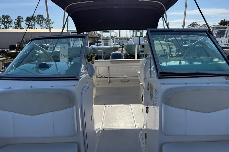 Slide: The Image of 2015 Robalo R227 Dual Console boat interior with seating and windshield. - 14