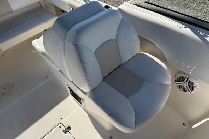 Slide: The Image of 2015 Robalo R227 Dual Console boat seat with speaker, showcasing comfortable design. - 17