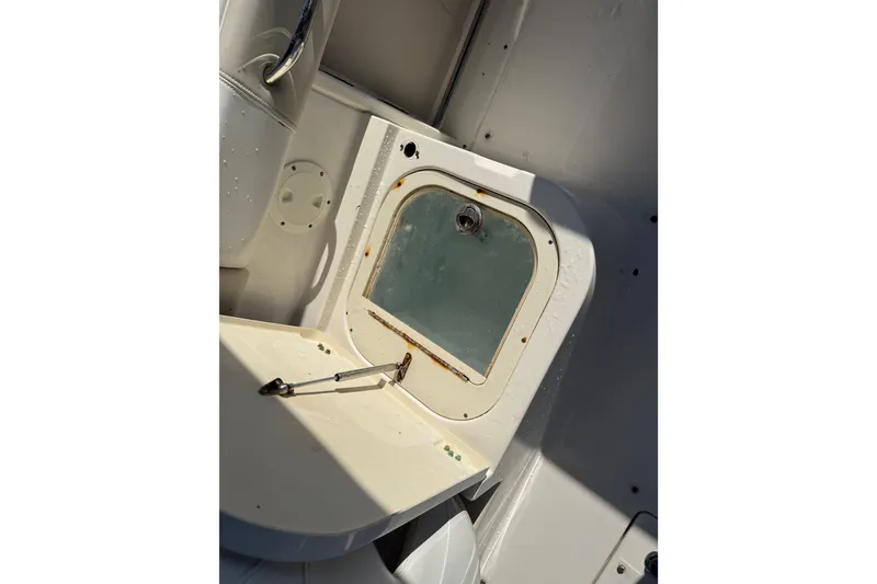 Slide: The Image of 2015 Robalo R227 Dual Console boat interior with storage compartment. - 25