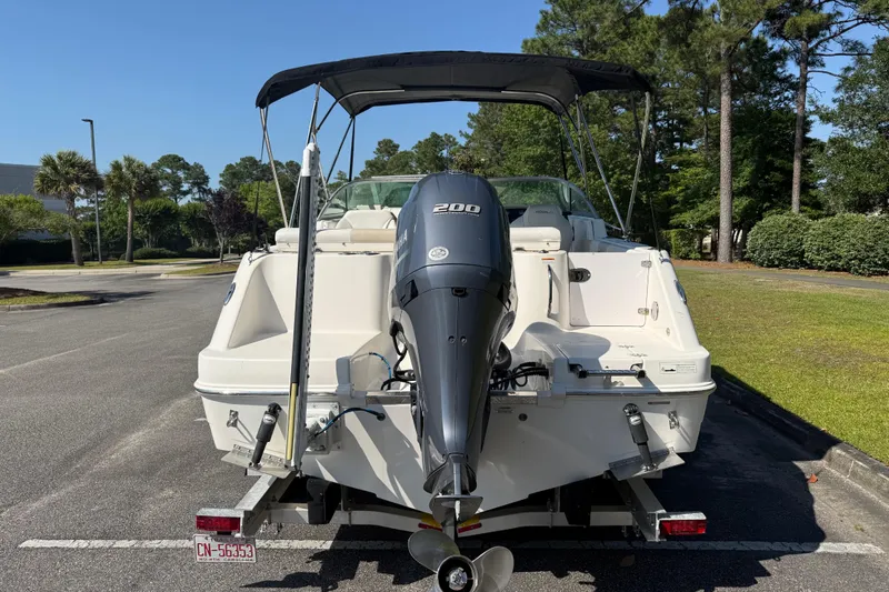 Slide: The Image of 2015 Robalo R227 Dual Console boat with Yamaha 200 engine, parked outdoors. - 5