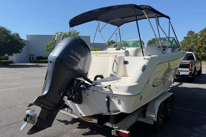 Slide: The Image of 2015 Robalo R227 Dual Console boat with Yamaha engine on trailer in parking lot. - 6