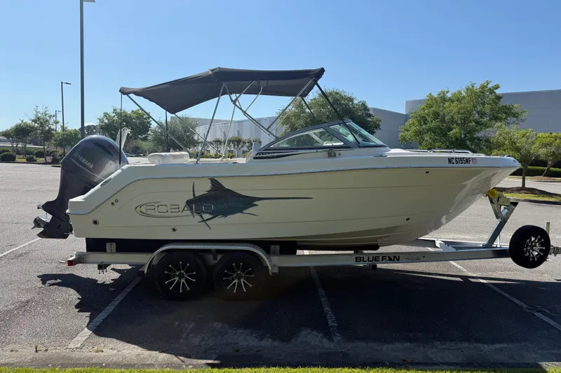 Slide: The Image of 2015 Robalo R227 Dual Console boat on trailer in parking lot. - 7