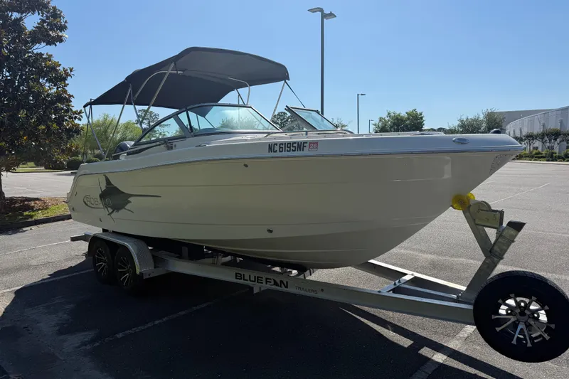 Slide: The Image of 2015 Robalo R227 Dual Console boat on trailer in parking lot. - 8