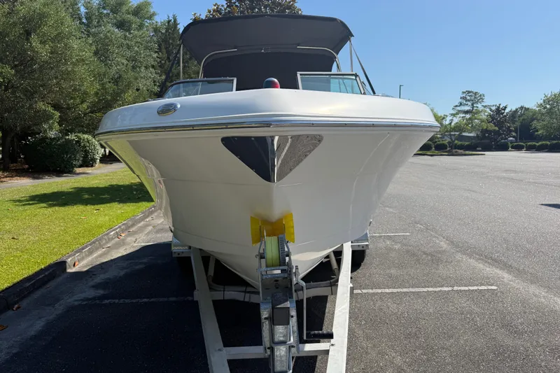 Slide: The Image of 2015 Robalo R227 Dual Console boat on trailer in sunny parking lot. - 9