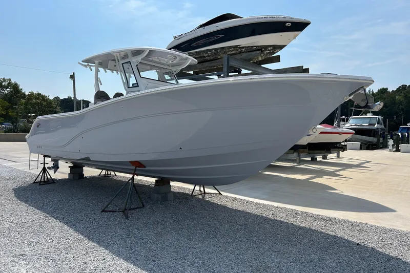 Slide: The Image of 2024 Sea Fox 328 Commander boat displayed on stands in a marina setting. - 3