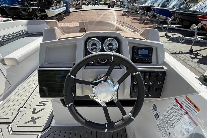 Slide: The Image of 2026 Starcraft SVX 211 OB boat dashboard with steering wheel and control panel. - 10