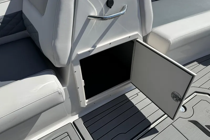 Slide: The Image of Open storage compartment on 2026 Starcraft SVX 211 OB boat with gray seating. - 15