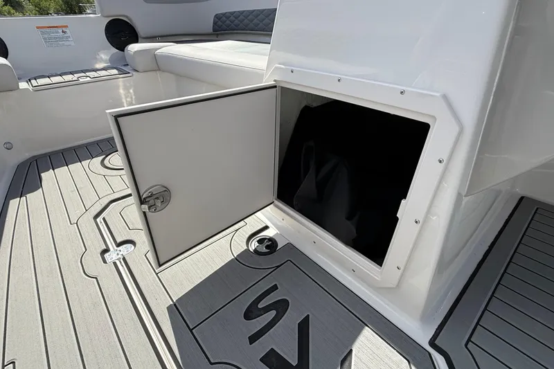 Slide: The Image of Open storage compartment on 2026 Starcraft SVX 211 OB boat deck. - 17
