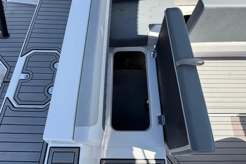 Slide: The Image of 2026 Starcraft SVX 211 OB boat with open storage compartment and sleek deck design. - 19