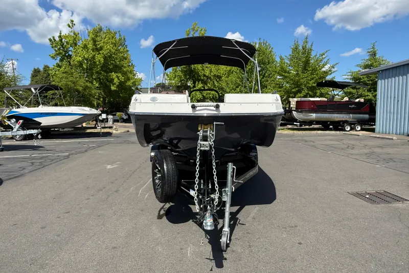 Slide: The Image of 2026 Starcraft SVX 211 OB boat on trailer, parked outdoors under a clear sky. - 2