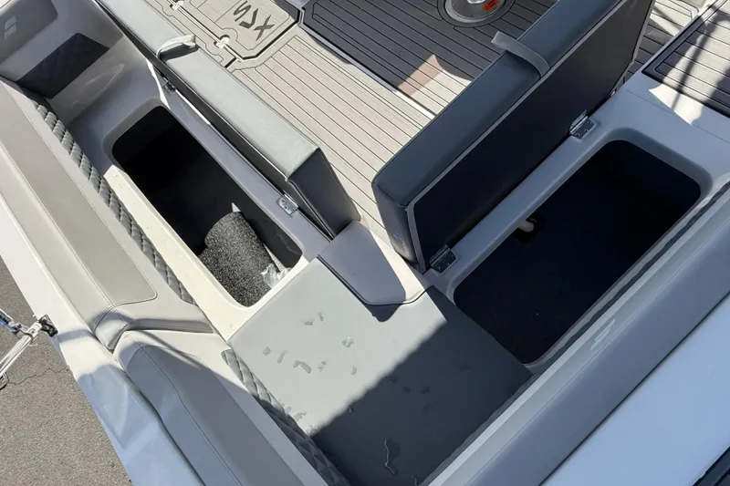Slide: The Image of 2026 Starcraft SVX 211 OB boat interior with open storage compartments and cushioned seating. - 20