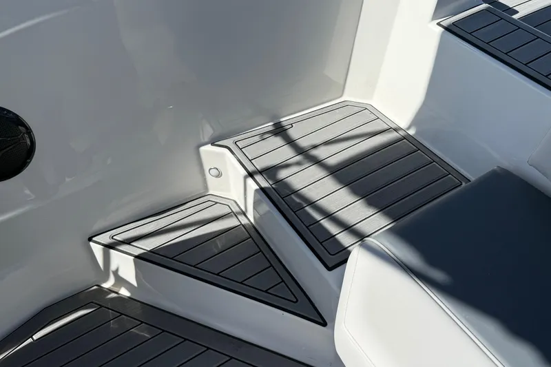Slide: The Image of Interior view of 2026 Starcraft SVX 211 OB boat, featuring sleek seating and flooring design. - 21