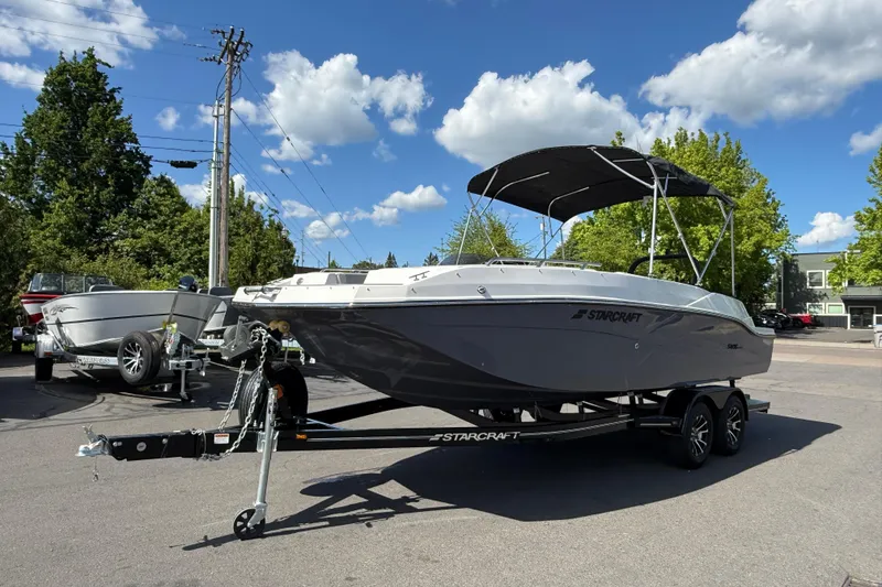 Slide: The Image of 2026 Starcraft SVX 211 OB boat on trailer under blue sky. - 4