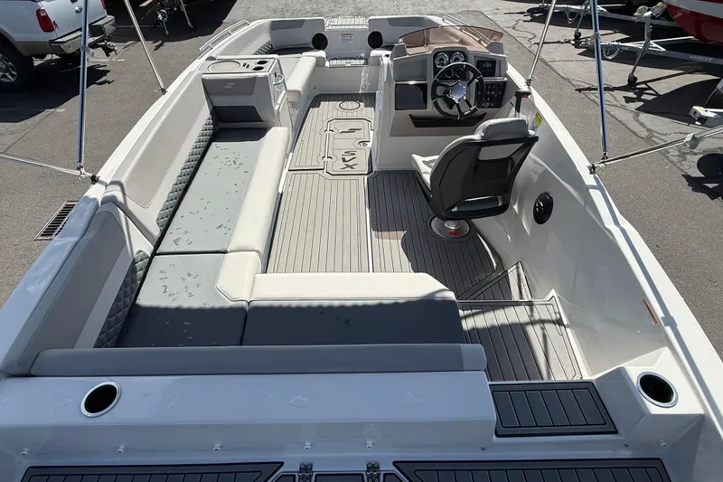 Slide: The Image of 2026 Starcraft SVX 211 OB boat interior with seating and steering console. - 5