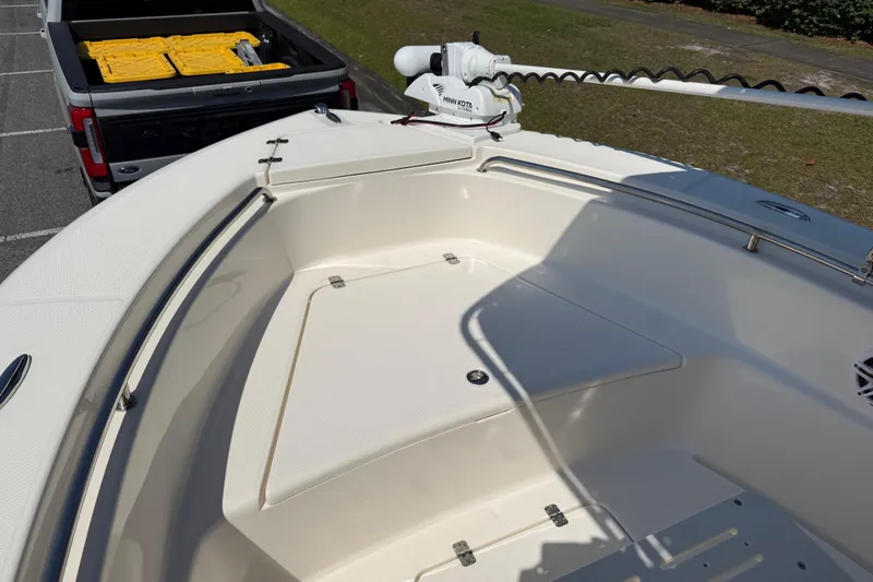 Slide: The Image of 2022 Bulls Bay 200 Center Console boat with trolling motor, parked near a truck. - 12